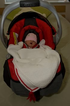 7 days old newborn in car seat.