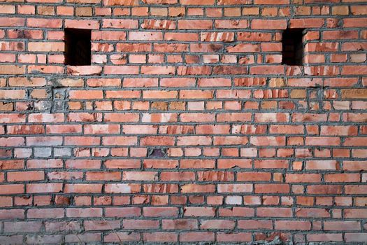 Red old brick wall structure with holes