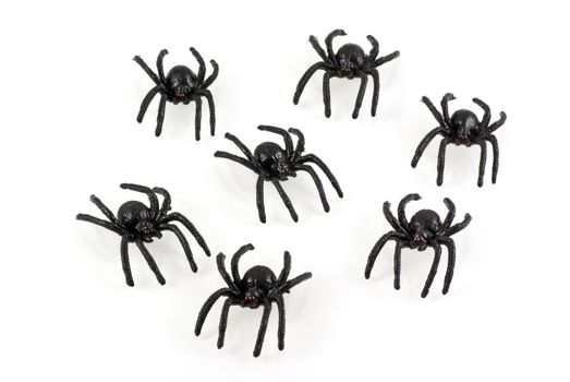 Black toy spiders colony, isolated on white.