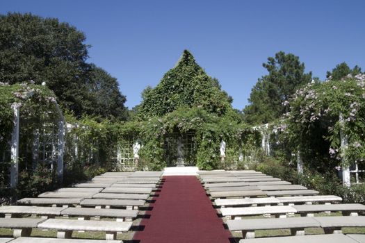 A outdoor wedding chapel surrounded by green vines