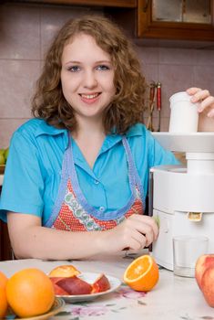 Girl with blender and fruits on home kitchen