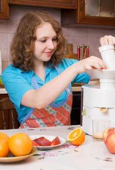 Girl with blender and fruits on home kitchen