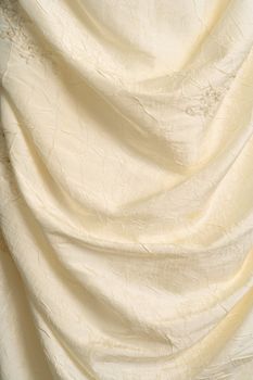 A background image of the flowing fabric of a wedding dress.
