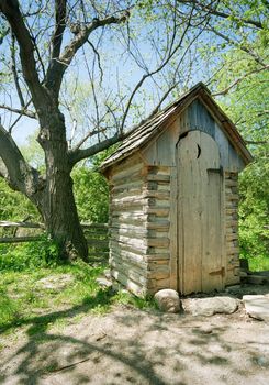 Image of an outhouse or outdoor toilet in the country.  Scanned from film negative.

