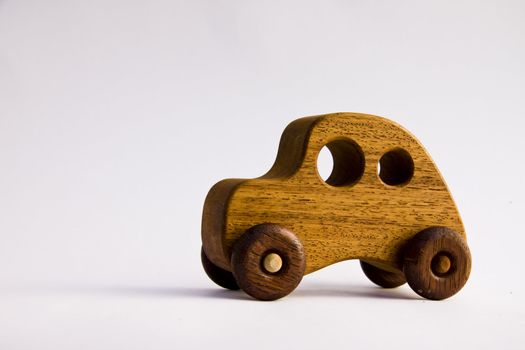 A funky wooden retro toy car over white with clipping path
