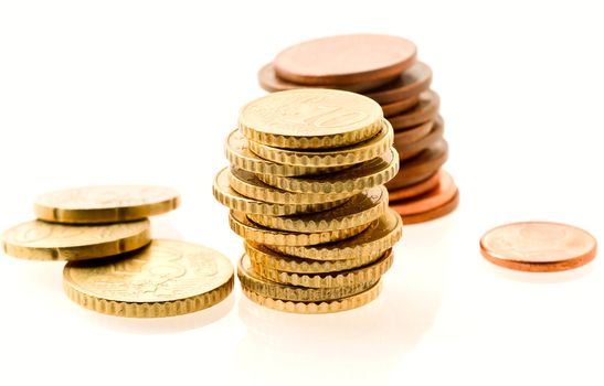 piles of european coins over white. Shallow DOF