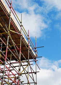 View of scaffolding tower against cloudy blue sky