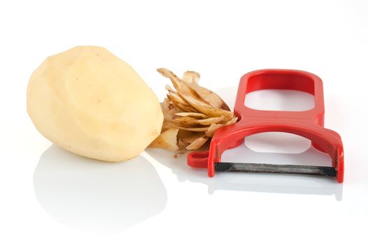 plastic potato pealer with peeled potatoes isolated on white background