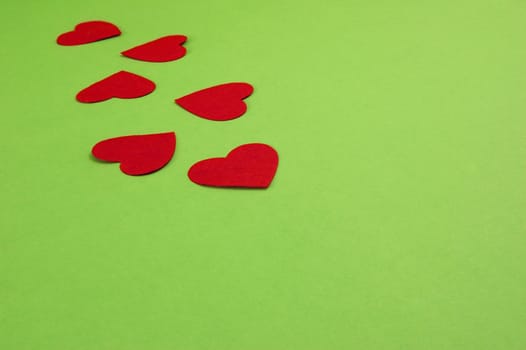 green background with red paper hearts