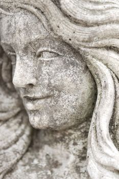 Detail of antique granite statue of woman.