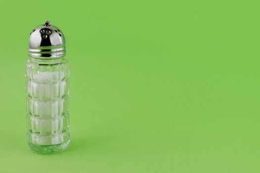 Salt Cellar on green background with copy space