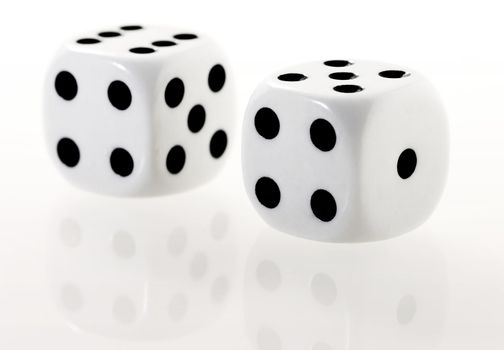 two white dices with reflection on the white table