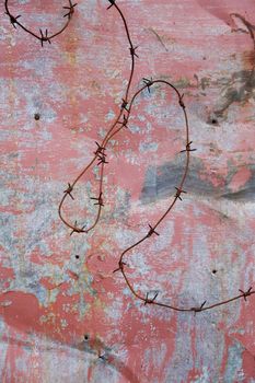Barbed wire on a background of a wall
