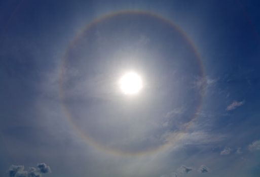 Circles halo in the blue sky around of the sun