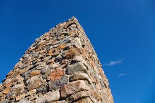 Stone column on a background of the blue sky