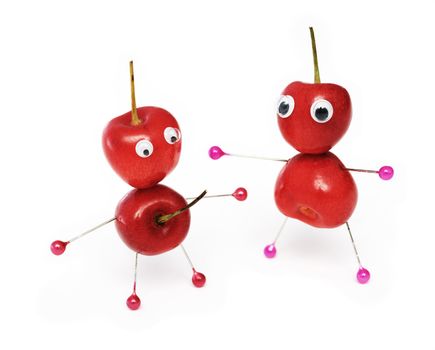 Two amusing little men collected from a sweet cherry