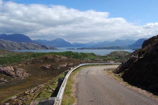 singletrack road in northern Scotland surrounded by beautiful scenery
