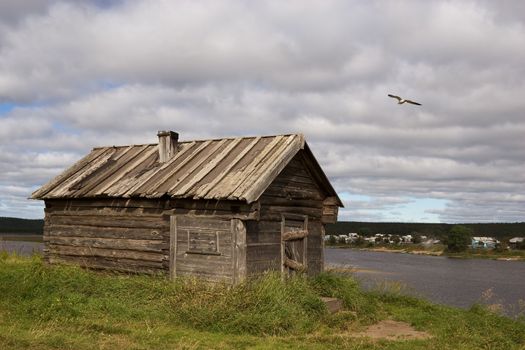 Old wooden bath on coast of the river