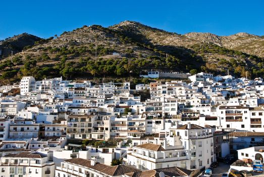 Typical Andaluz village of whitewashed buildings perched high on the mountainside.