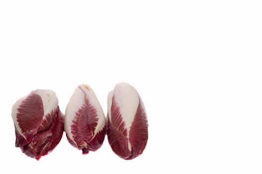 three fresh organic red endives, isolated on white