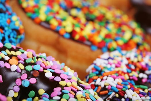 Colorful donuts on plate