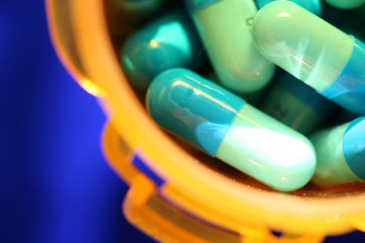 Medicine, pills against blue background