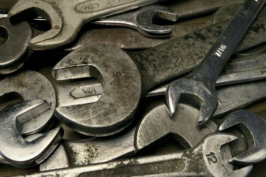 Pile of old used and dirty wrenches.
