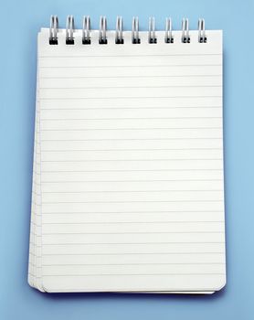 An image of a lined note pad with spiral binding.  Clipping path is included in file.
