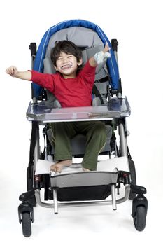 Three year old disabled boy in medical stroller