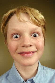 A young boy excited and surprised.
