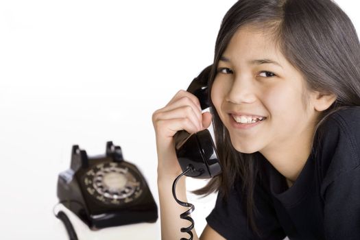 Young girl talking on old fashioned phone