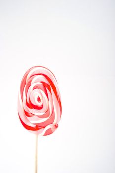 Image of a red, pink, and white swirly lollipop