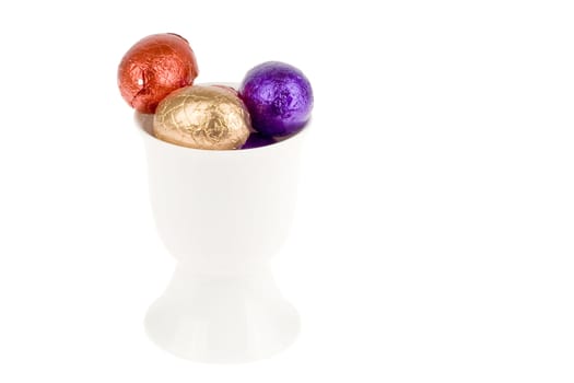 an egg cup with chocolate eggs