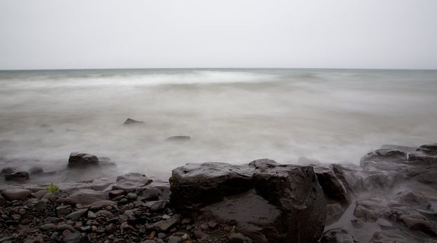 Fog, mist, water, and stone on a slow exposure of Lake Superior in Northern Minnesota,