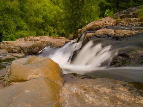 Rapids falling down into a forest in the North Woods of Minnesota.