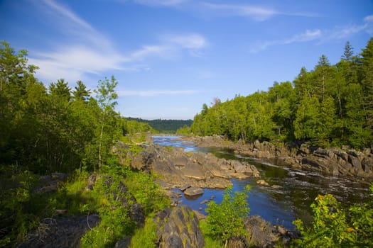 River and stone pas through the North Woods of Minnesota.