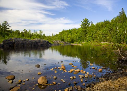 Stones leading into a reflection in the North Woods of Minnesota,