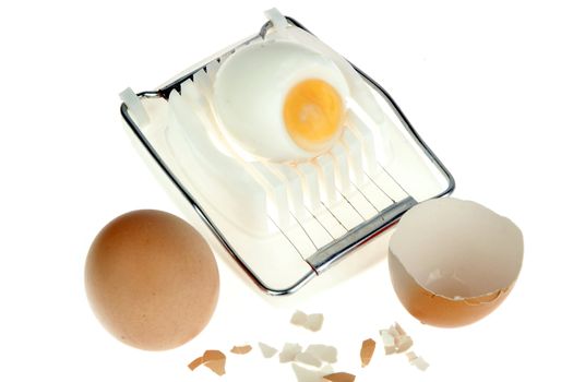 an egg-cutter with an egg and eggshells