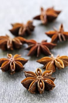 Dry star anise fruit and seeds on wooden background