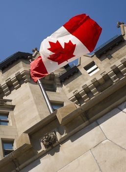 Building with the Canadian flag in the wind