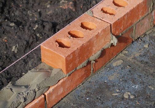 Close up of wall being constructed from bricks