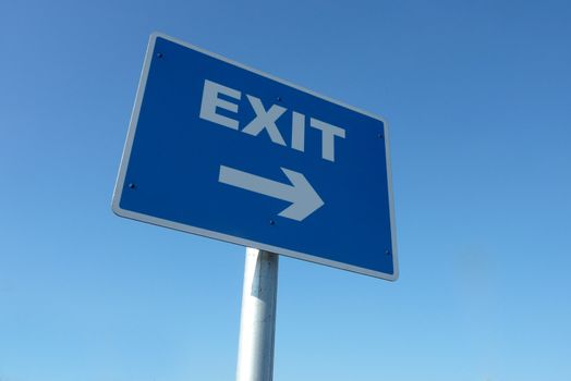 Closeup of exit traffic sign against cloudless blue sky