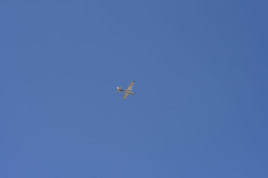 Airplane in the blue sky of Latvia