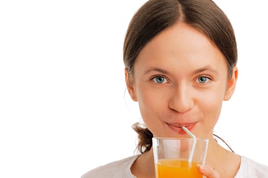 Closeup of a Beautiful young woman sipping juice with a straw on white background 