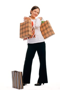 Full length of an attractive young woman shopping on white background