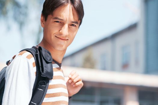 Close-up image of a young man with bag in the town
