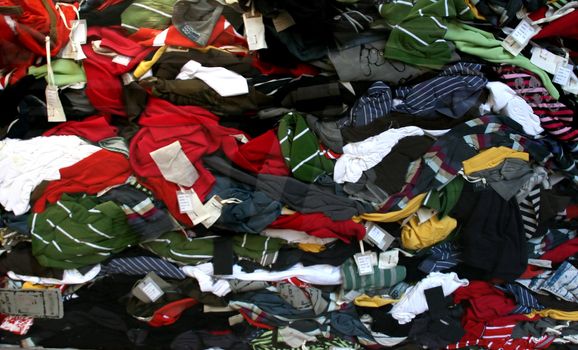 background image of a bundle of t-shirts, fashion industry