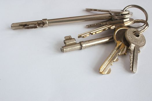 large bunch of housekeys over a light background