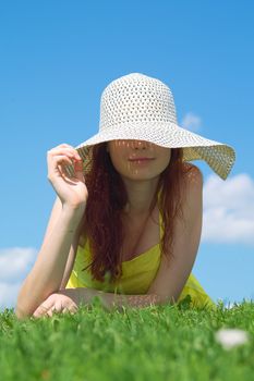 A beautiful girl on yellow dress and hat enjoying summer