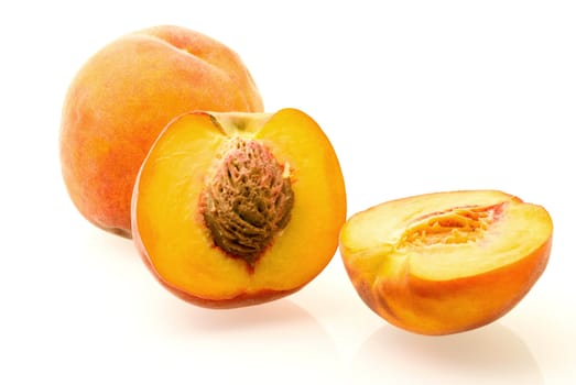 fresh ripe juicy peaches over white background